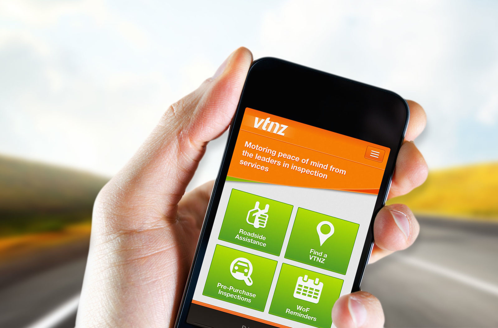 Photo of hand holding a mobile phone showing the VTNZ mobile website